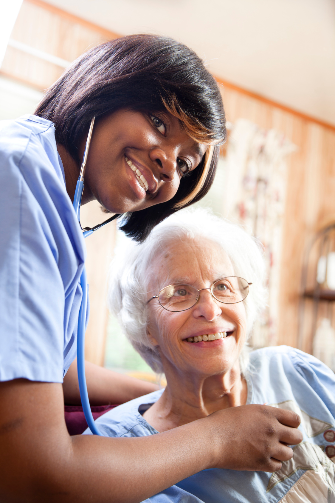 Healthcare: Home health nurse examines senior patient.